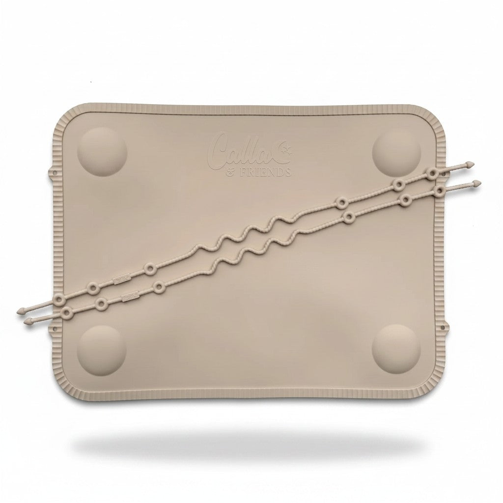 Mom & Me Boutique Tidy Traveler silicone suction placemat in beige with two removable tethers for baby utensils