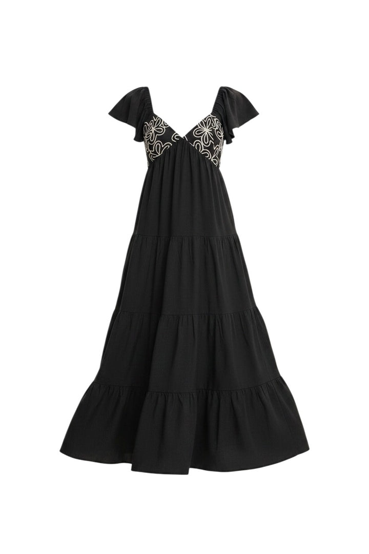 Mom & Me Boutique black maxi dress with deep v-neck, white floral embroidery, flutter sleeves, and tiered ruffles.