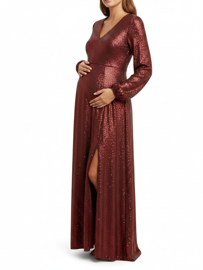 Mom & Me Boutique burgundy sequin maternity maxi dress with long sleeves, v-neck, and side slit on a pregnant model.