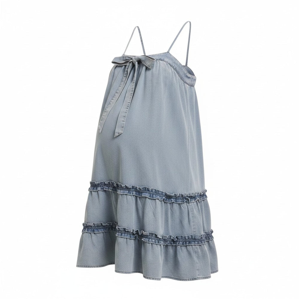 Mom & Me Boutique Harlee denim babydoll mini dress with spaghetti straps, front bow, and tiered ruffled hem.