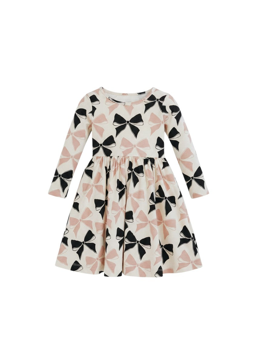 Mom & Me Boutique Heidi twirl dress in cream with black and pink bow print, featuring long sleeves and circle skirt.