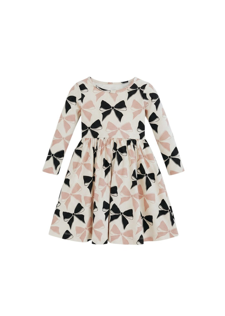 Mom & Me Boutique Heidi twirl dress in cream with black and pink bow print, featuring long sleeves and circle skirt.