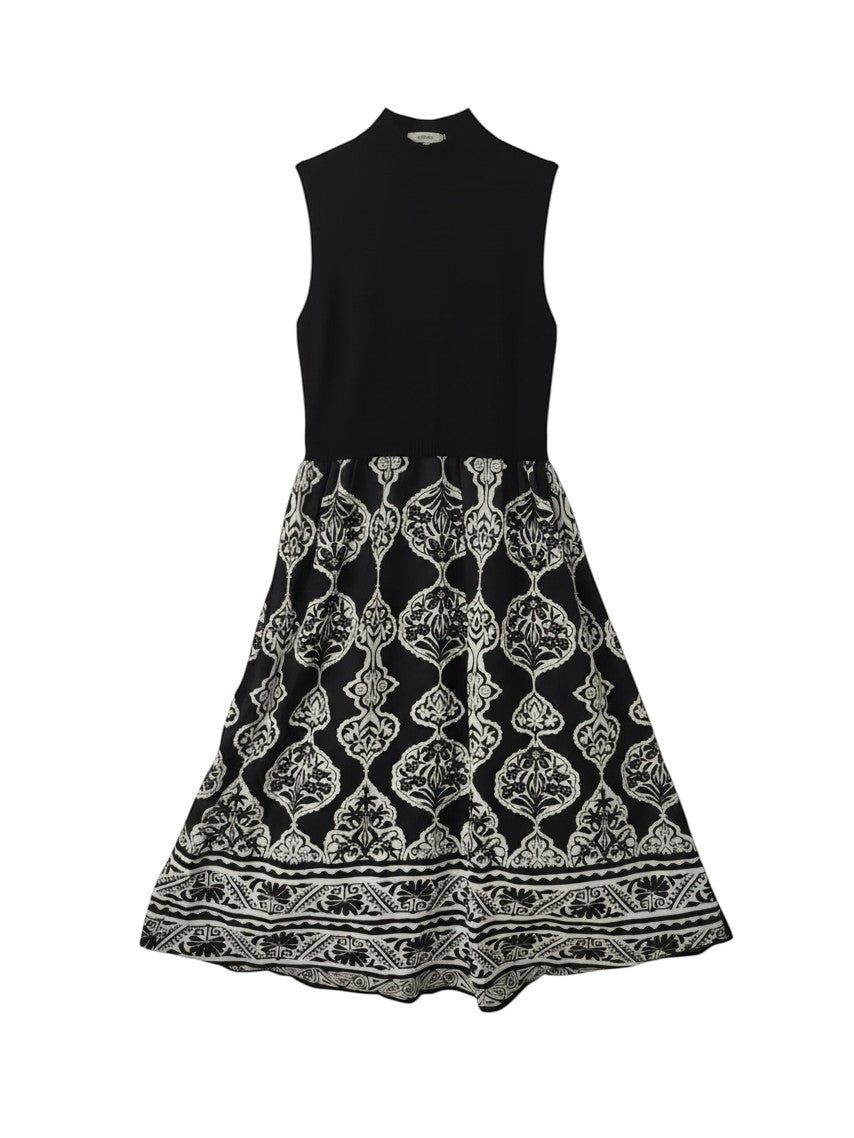Mom & Me Boutique Izabella sleeveless black dress with a high neck and a white patterned flared skirt.