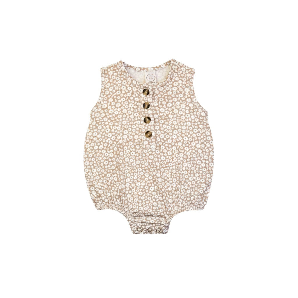 Mom & Me Boutique Laynie bubble romper in beige with a white floral print, featuring front buttons and snap closure.