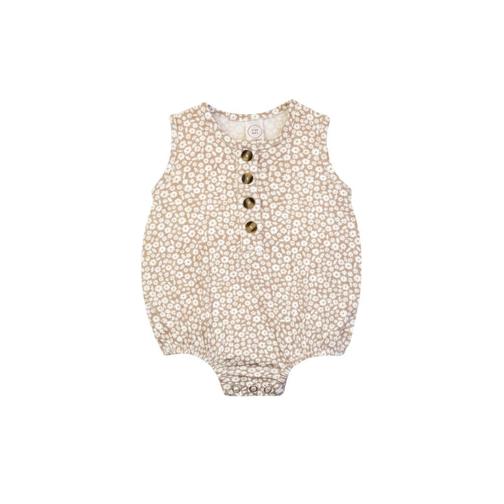 Mom & Me Boutique Laynie bubble romper in beige with a white floral print, featuring front buttons and snap closure.