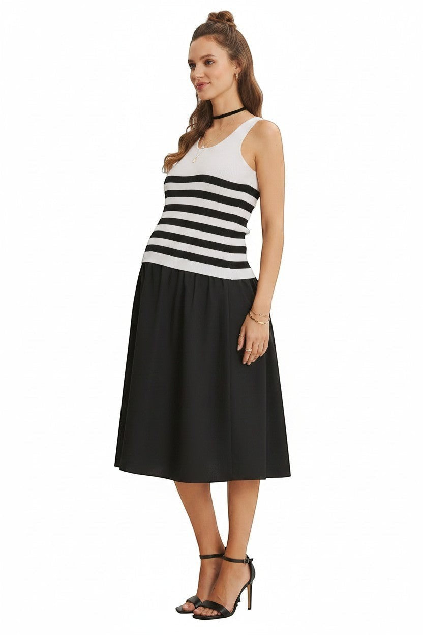 Model wearing Mom & Me Boutique Rosalie midi dress with ivory and black striped ribbed top and crisp cotton skirt