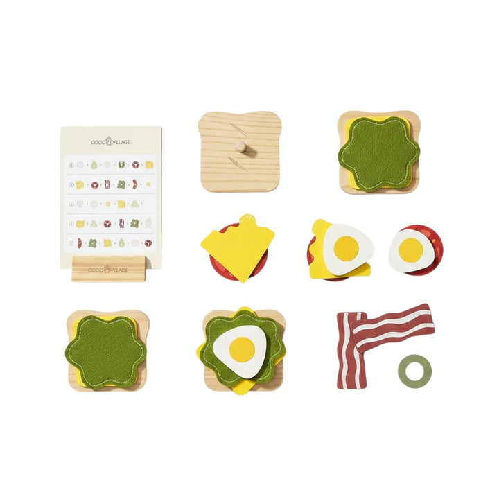 Mom & Me Boutique wooden stackable sandwich toy set with various food ingredients and an illustrated assembly guide.